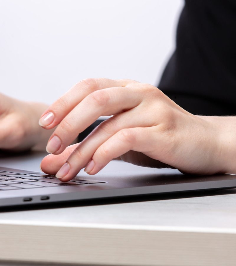 front-view-young-lady-using-her-silver-laptop-job-work-computer (1)